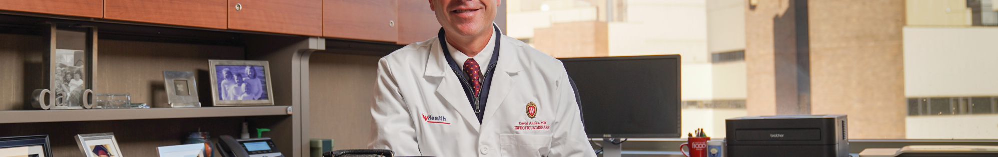 Dr. David Andes in his office with Dr. William A. Craig's medical bag on his desk