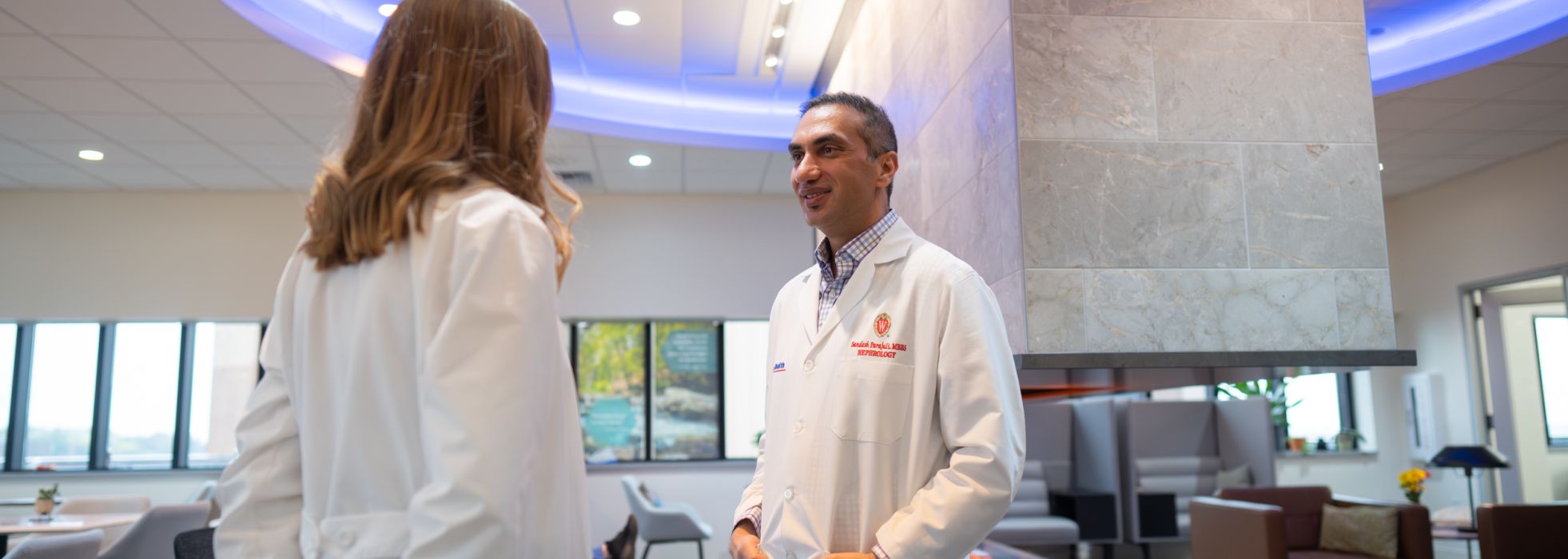 Dr. Sandesh Parajuli and Lindsey Murphy, NP, chat in the UW Hospital Collaboration Zone
