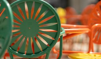 Green and orange chairs at a table