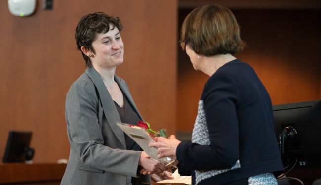 Margo Heston, BS, a graduate student researcher with the Division of Geriatrics and Gerontology, receives one of the poster session awards for clinical research from Department Chair Lynn Schnapp, on right.