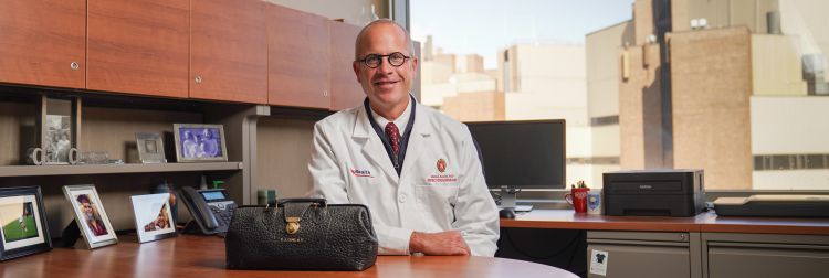 Dr. David Andes sits at his desk