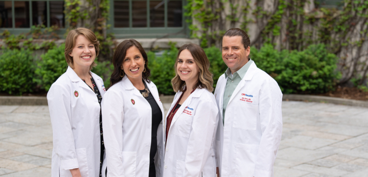 The 2022-23 chief residents, in a group outside and wearing their white coats.