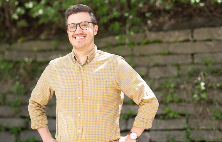 Photo of Dr. Michael Houghan wearing a brownish-yellow button down shirt.