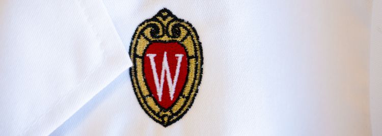 White coat with embroidered UW–Madison crest