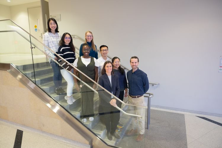 Kruser lab members standing on stairs