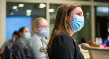 Drs. Marina Sharifi, Dana Ley, and Sara Donohue watching someone out-of-frame speak