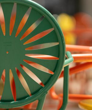 Green and orange chairs at a table