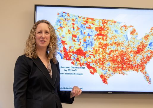 Dr. Amy Kind with a display of the Neighborhood Atlas map. Credit: Clint Thayer/Department of Medicine
