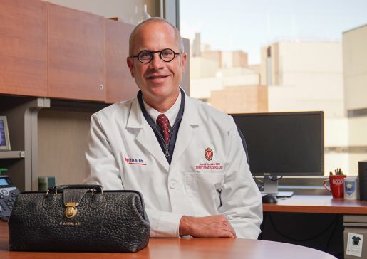 Dr. David Andes, the inaugural William A. Craig endowed professor and chief of the Division of Infectious Disease in the Department of Medicine, in his office with a keepsake—Dr. Craig’s medical bag.