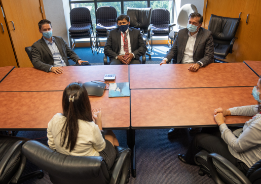 ICU Data Science Lab members talk around a conference room table