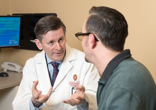Dr. Lucey talks with a patient in a clinical setting